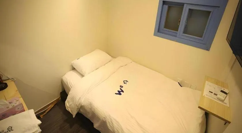 Bed in W Mini Hotel