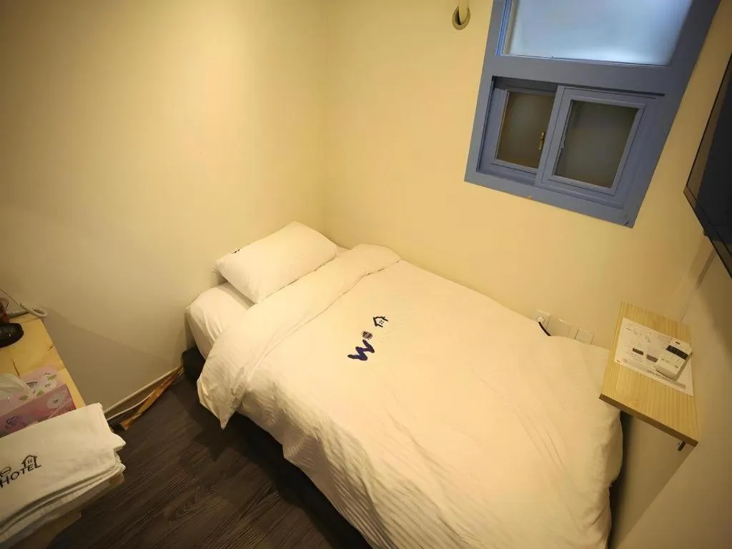 Bed in W Mini Hotel