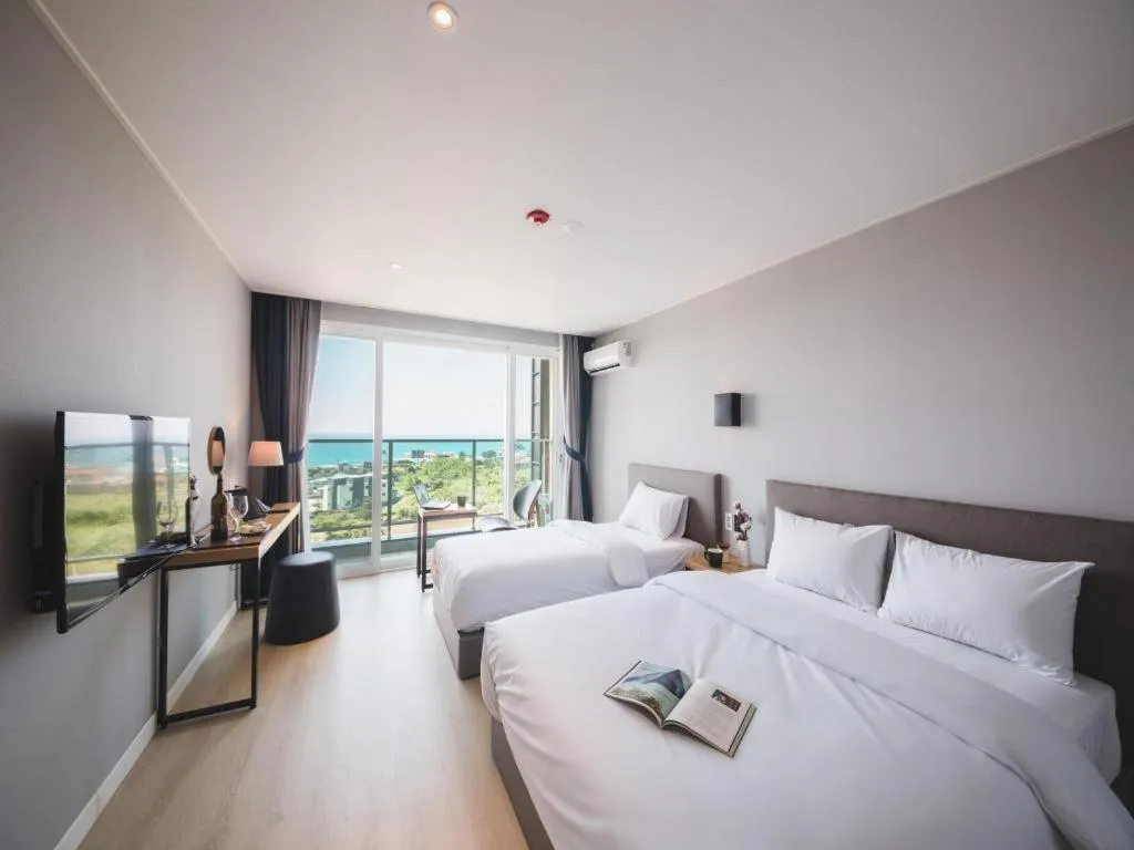 Bed in Sallys Jeju Hotel