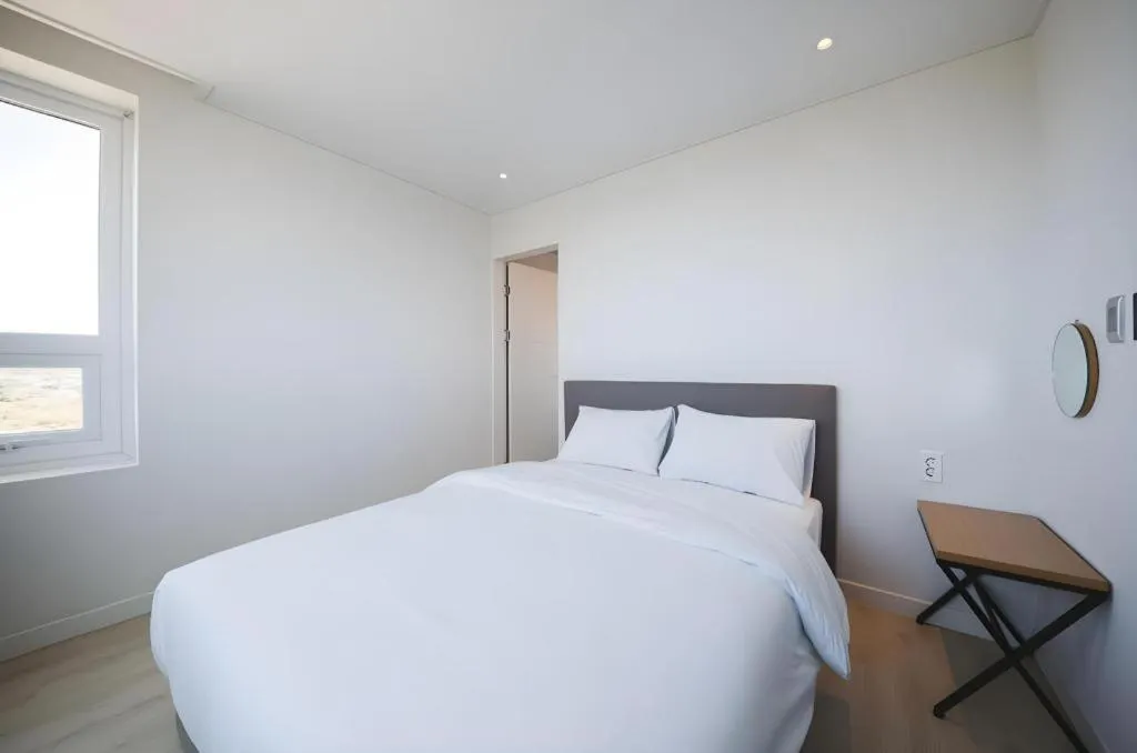 Bed in Sallys Jeju Hotel