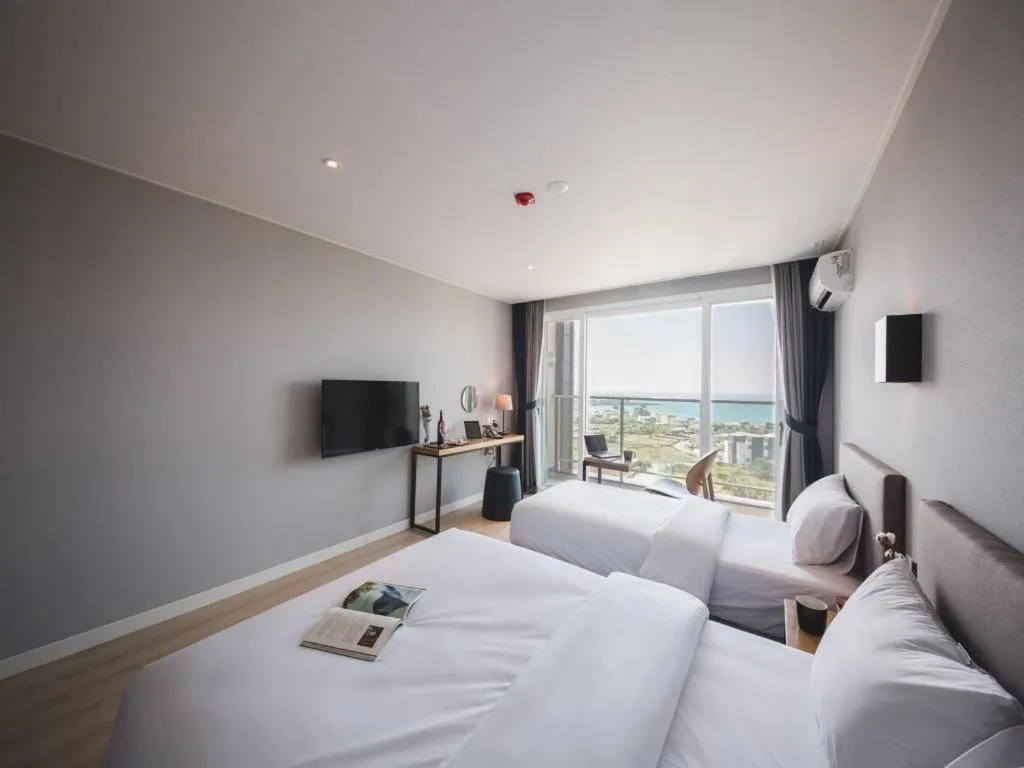 Bed in Sallys Jeju Hotel