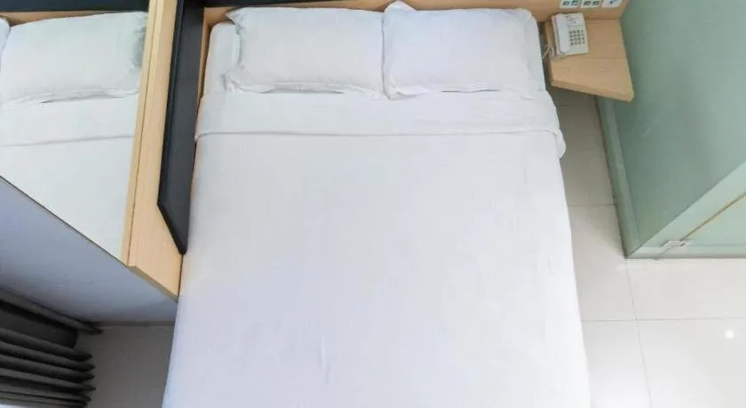 Bed in G Suites Hotel By AMITHYA