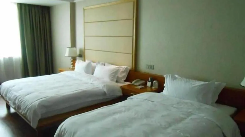 Bed in San Jiang Grand Hotel