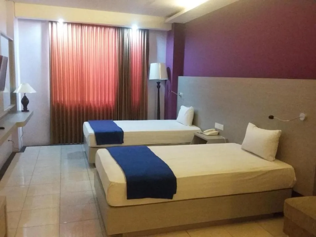 Bed in Kharisma Hotel