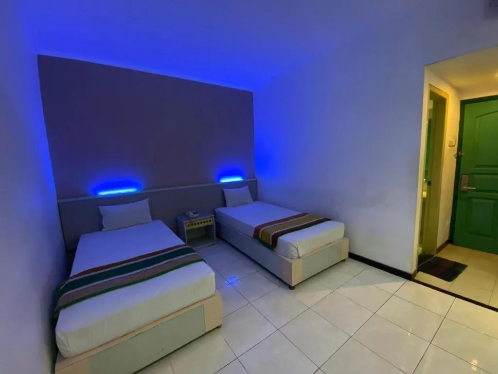 Bed in Kharisma Hotel