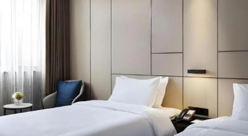 Bed in Zhonghao Boutique Hotel Dalang Business Center