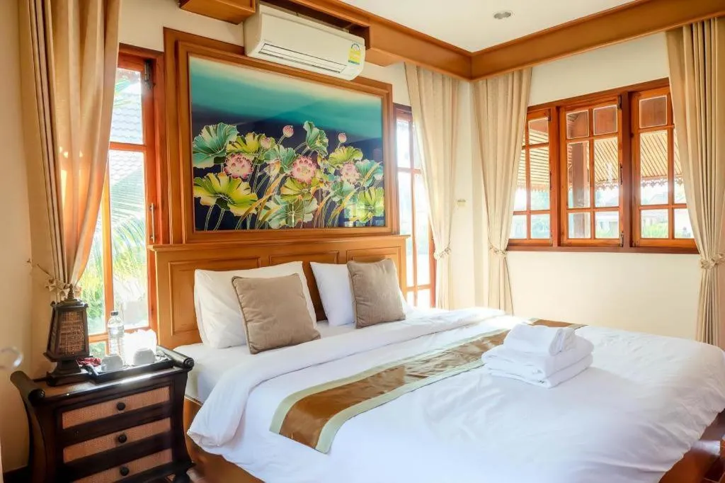 Bed in THAISOMBOON BIGHOME RESORT
