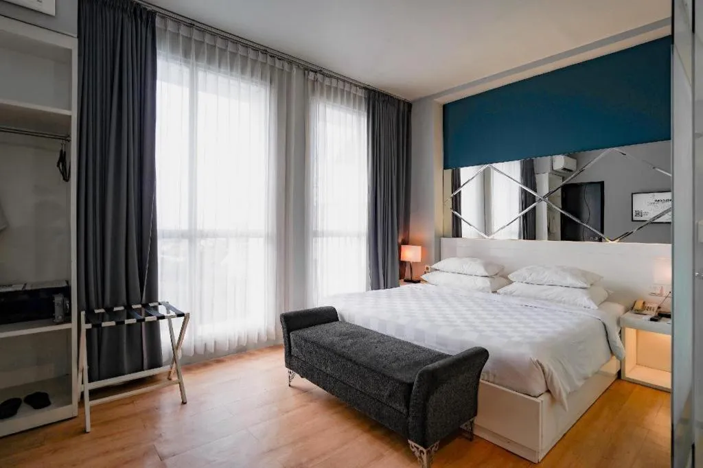 Bed in Grand Darmo Suite by AMITHYA