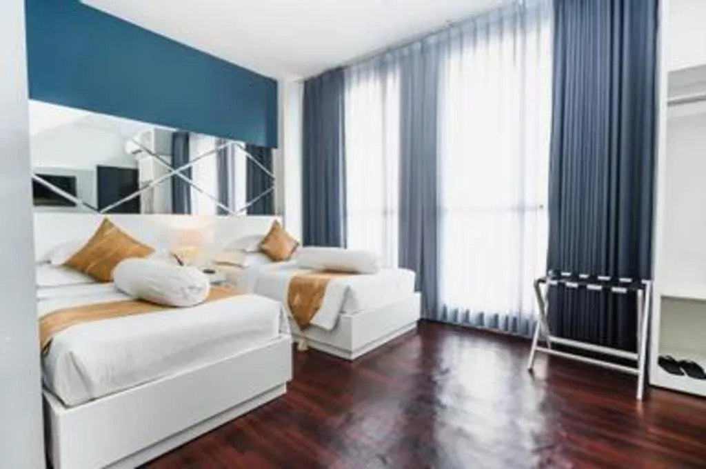 Bed in Grand Darmo Suite by AMITHYA