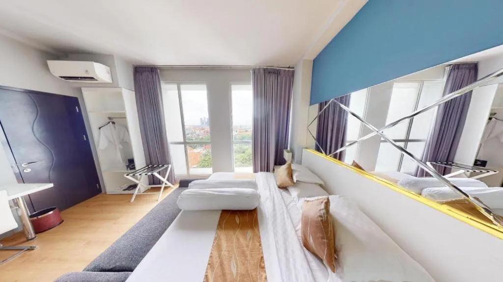 Bed in Grand Darmo Suite by AMITHYA