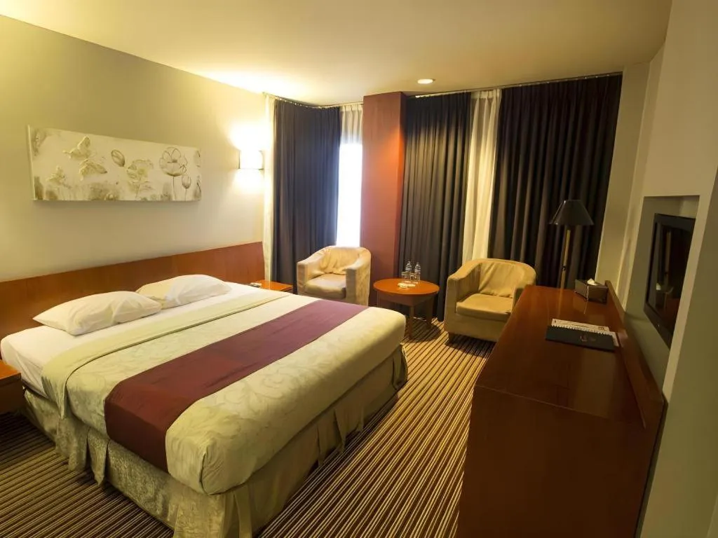 Bed in Kenari Tower Hotel