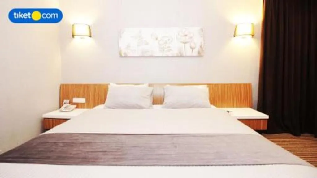 Bed in Kenari Tower Hotel