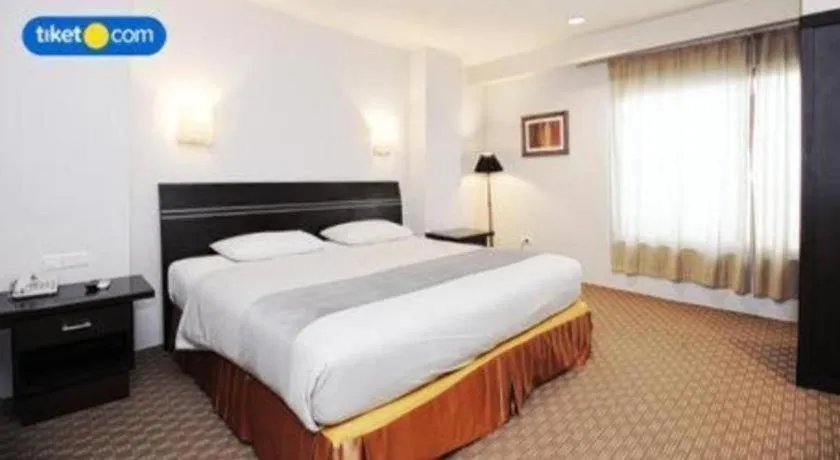 Bed in Kenari Tower Hotel