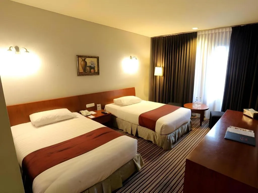 Bed in Kenari Tower Hotel