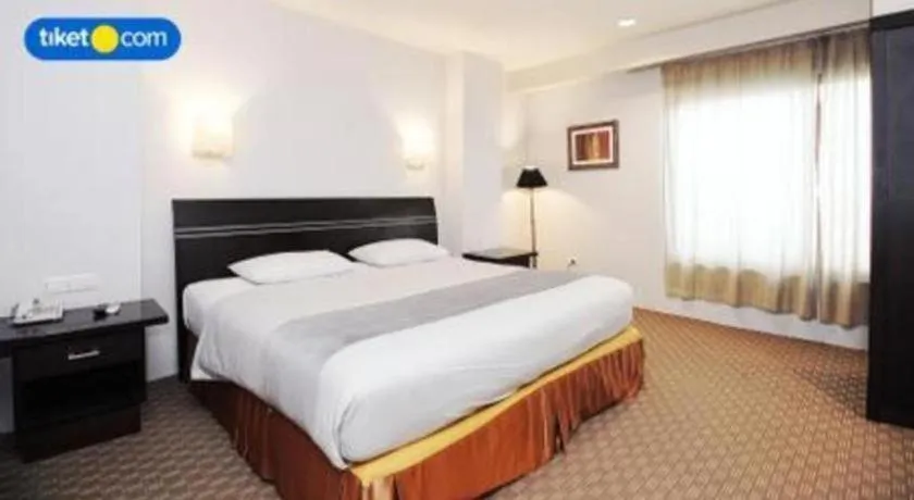 Bed in Kenari Tower Hotel