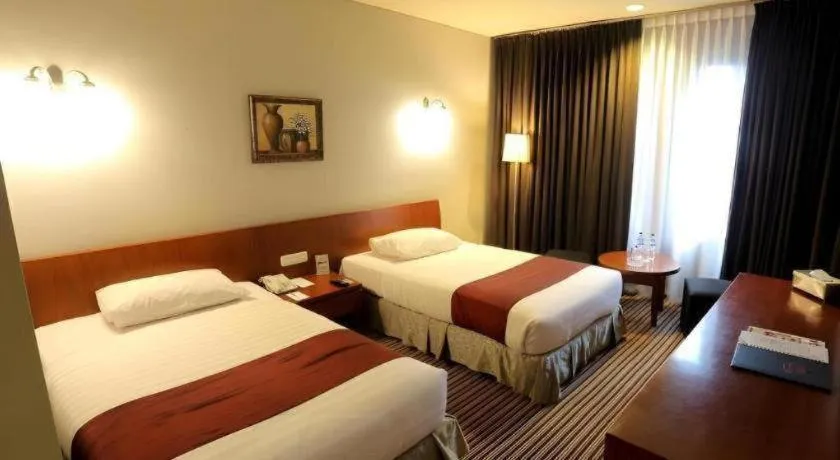 Bed in Kenari Tower Hotel