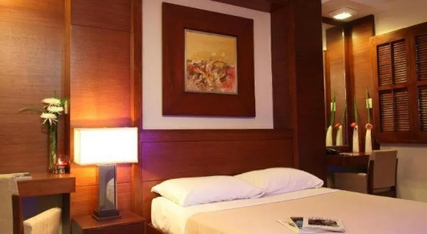 Bed in Amorsolo Mansion Hotel