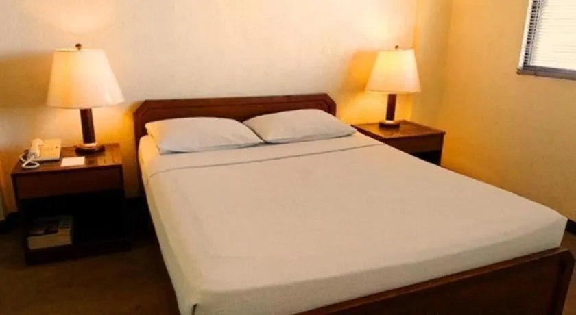 Bed in Amorsolo Mansion Hotel