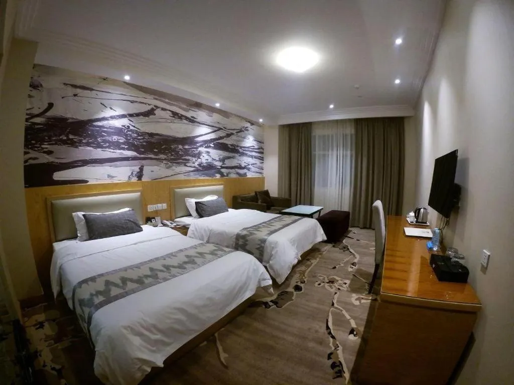 Bed in ST. MORITZ BUSINESS HOTEL