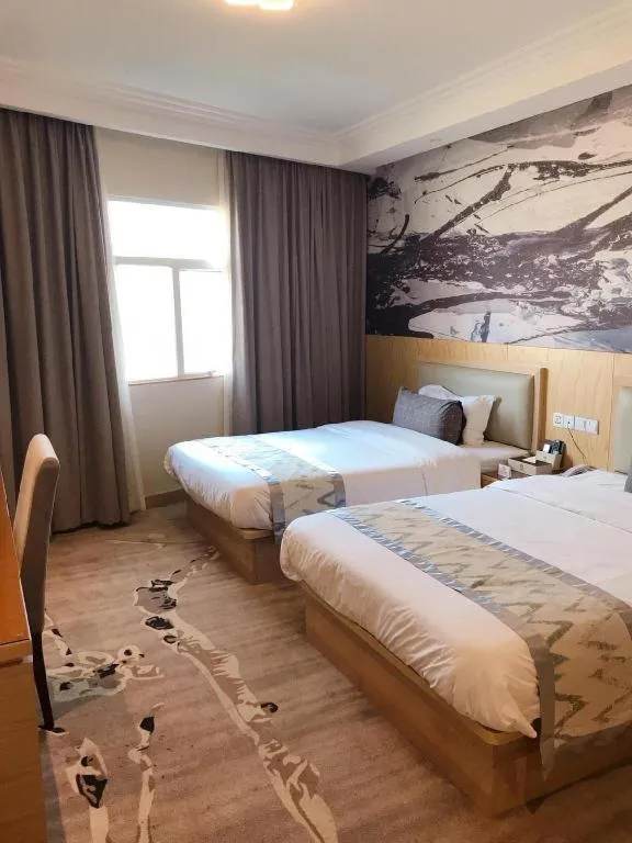 Bed in ST. MORITZ BUSINESS HOTEL