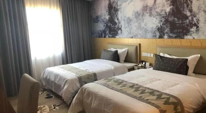 Bed in ST. MORITZ BUSINESS HOTEL