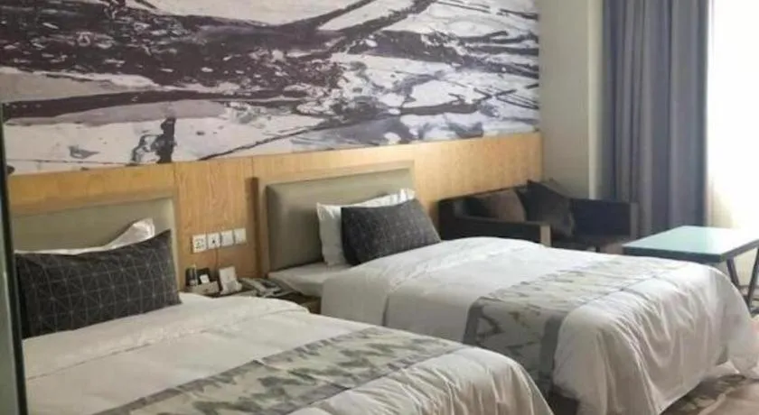 Bed in ST. MORITZ BUSINESS HOTEL