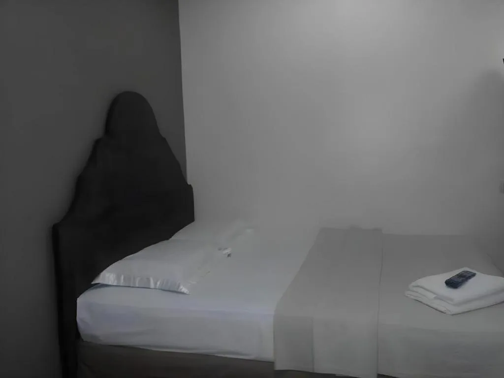 Bed in Rich Manor Pension House