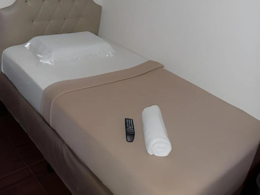 Bed in Rich Manor Pension House