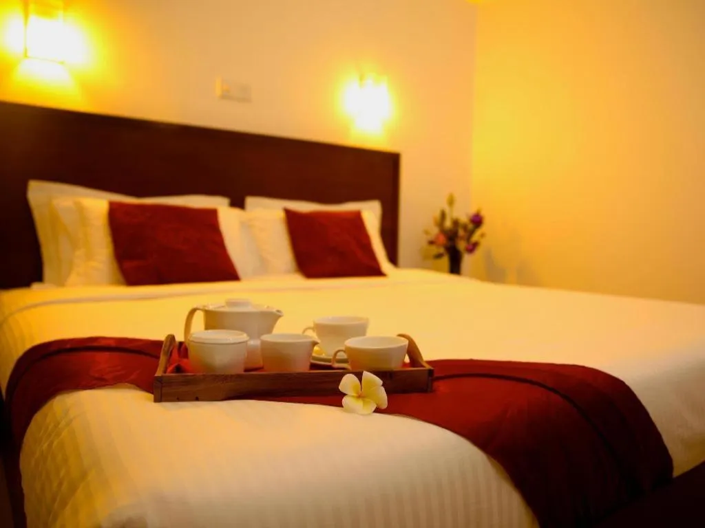 Bed in Whispering Palms Hotel