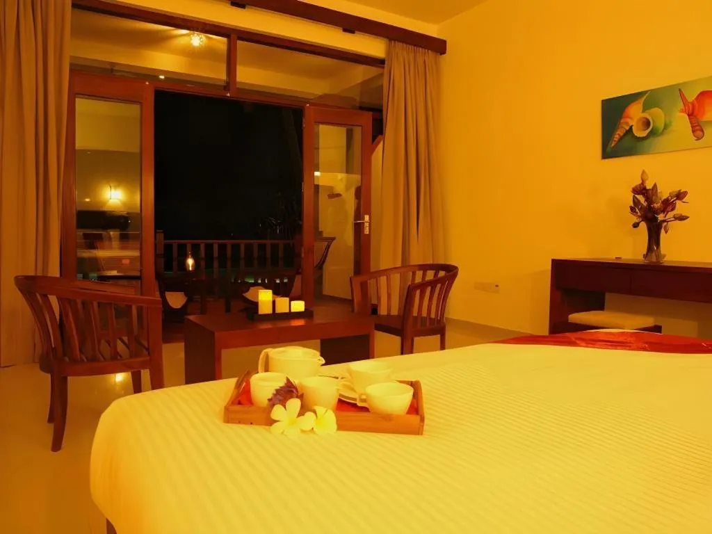 Bed in Whispering Palms Hotel