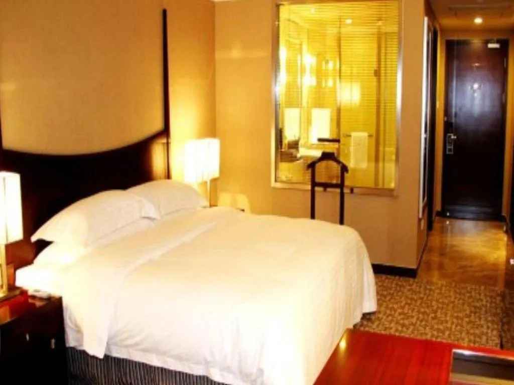 Bed in Grand New Century Hotel Binhai Tianjin