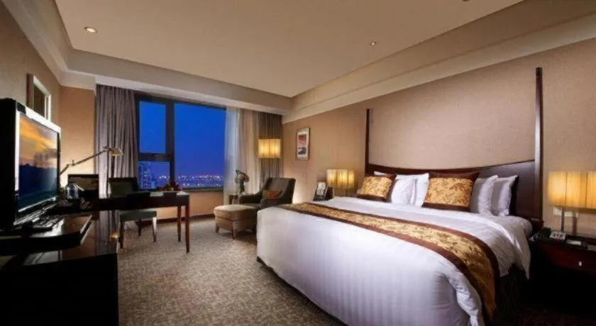 Bed in Grand New Century Hotel Binhai Tianjin