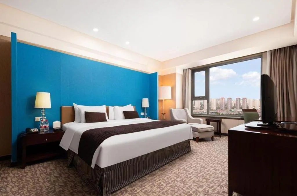 Bed in Grand New Century Hotel Binhai Tianjin
