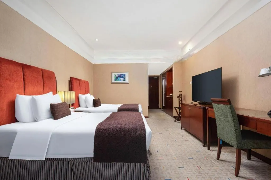 Bed in Grand New Century Hotel Binhai Tianjin