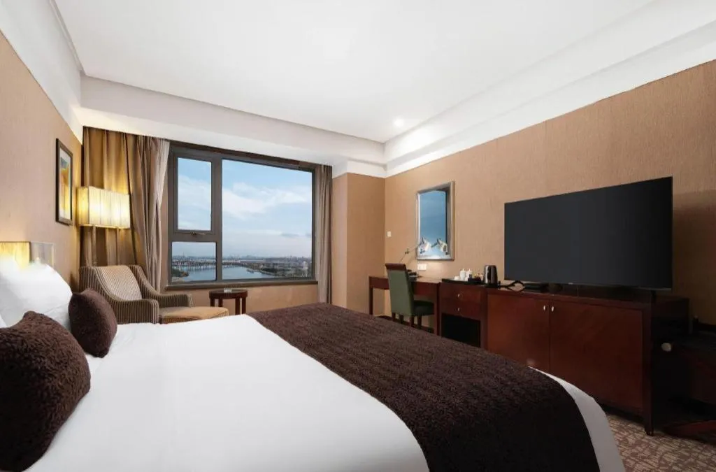 Bed in Grand New Century Hotel Binhai Tianjin