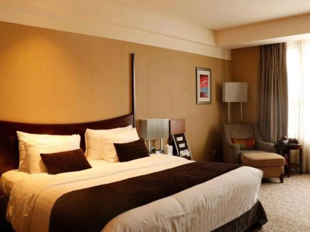 Bed in Grand New Century Hotel Binhai Tianjin