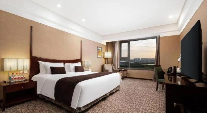 Bed in Grand New Century Hotel Binhai Tianjin