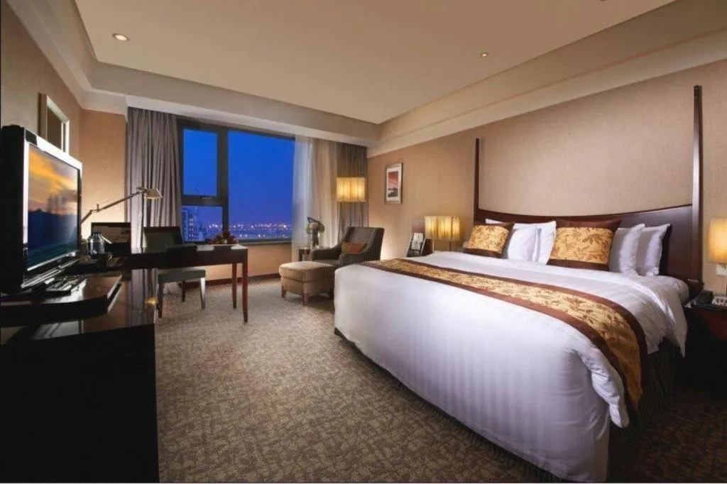 Bed in Grand New Century Hotel Binhai Tianjin