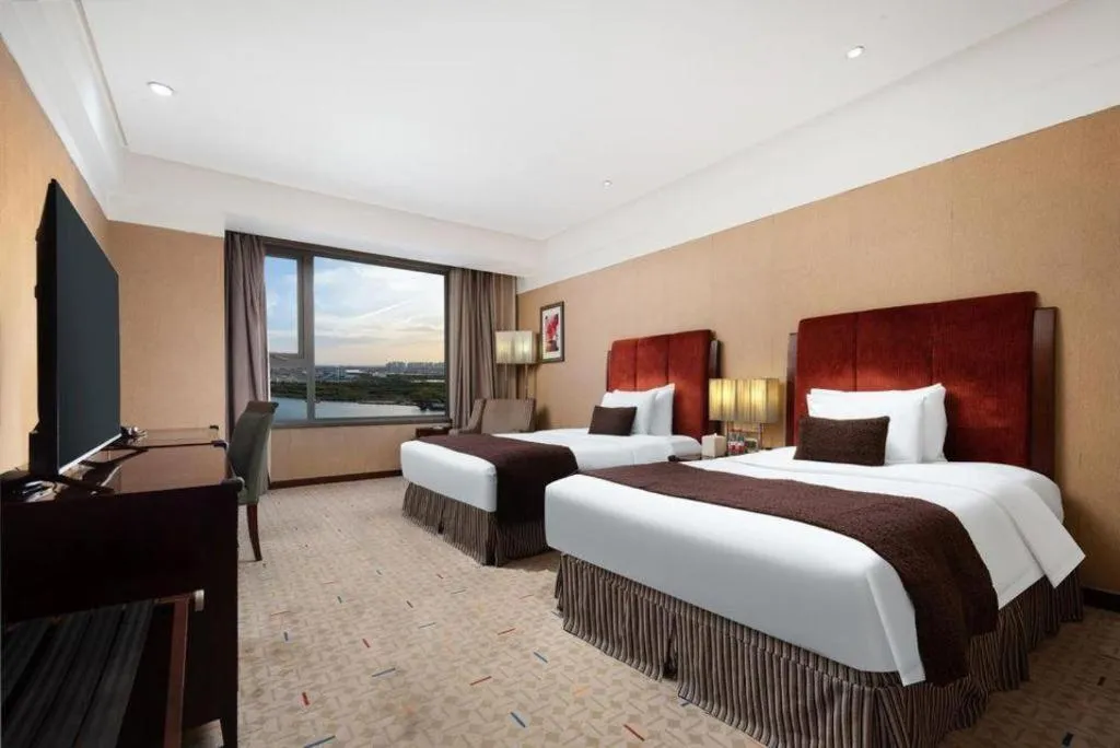 Bed in Grand New Century Hotel Binhai Tianjin