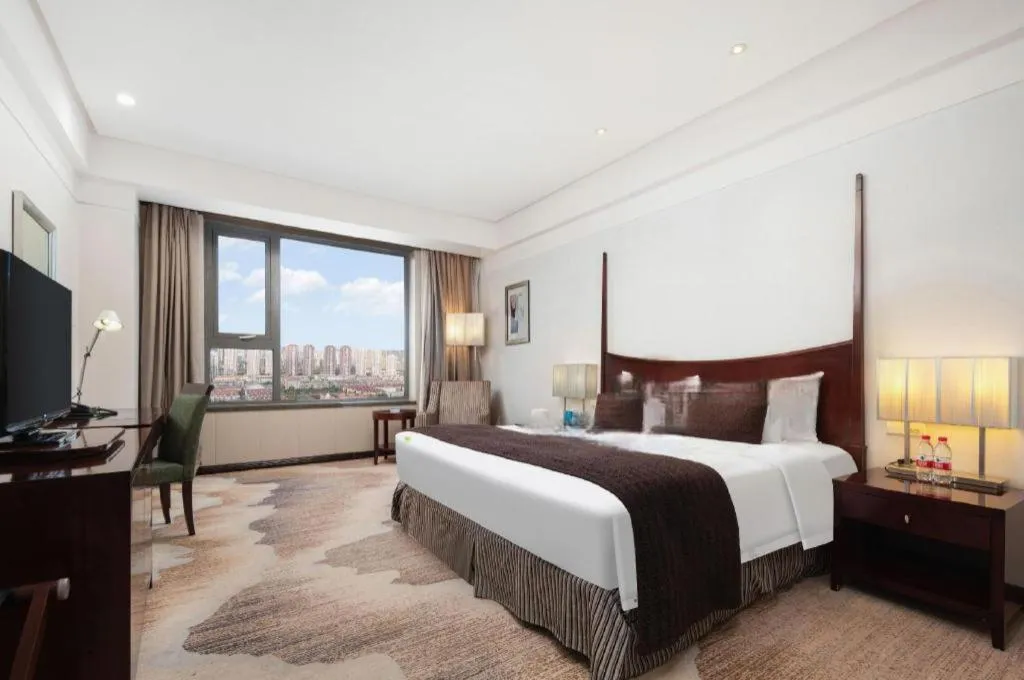 Bed in Grand New Century Hotel Binhai Tianjin