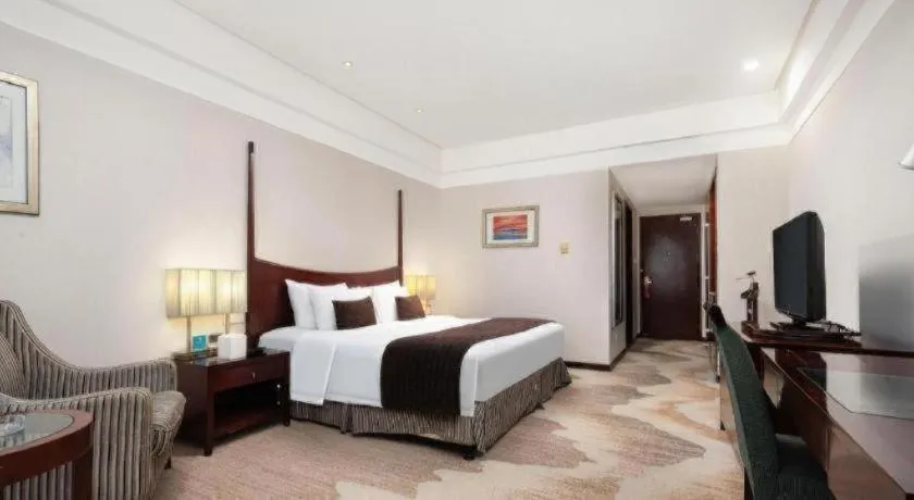 Bed in Grand New Century Hotel Binhai Tianjin