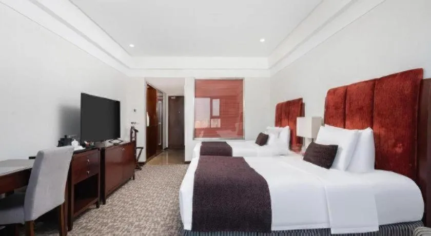 Bed in Grand New Century Hotel Binhai Tianjin