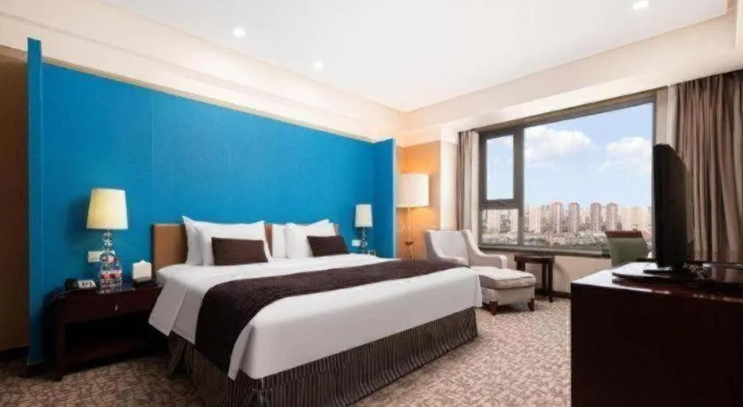 Bed in Grand New Century Hotel Binhai Tianjin