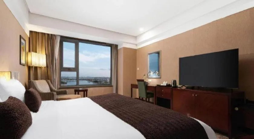 Bed in Grand New Century Hotel Binhai Tianjin