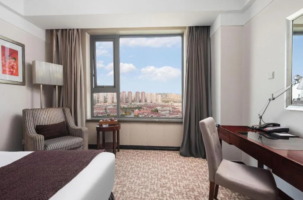 Bed in Grand New Century Hotel Binhai Tianjin