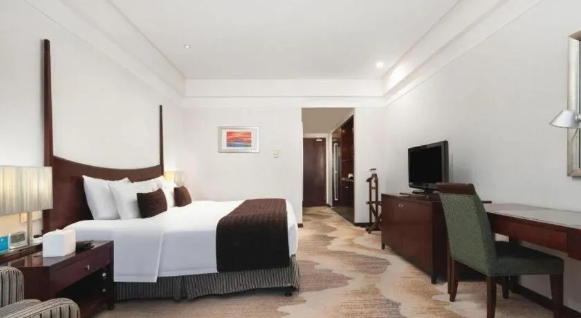 Bed in Grand New Century Hotel Binhai Tianjin