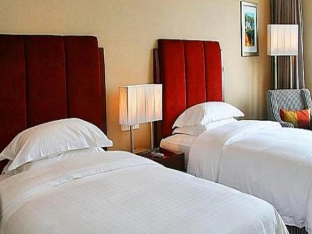 Bed in Grand New Century Hotel Binhai Tianjin