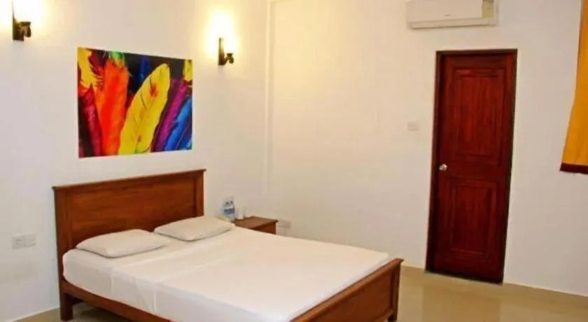 Bed in OYO 246 Roy Villa Beach Hotel