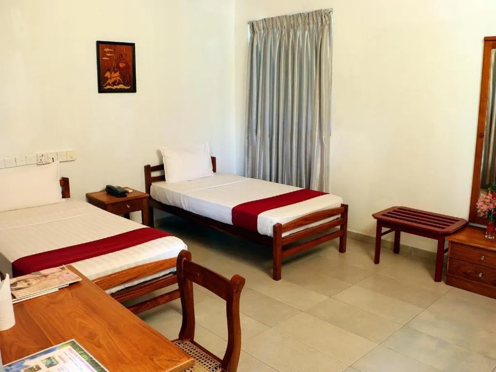 Bed in OYO 246 Roy Villa Beach Hotel