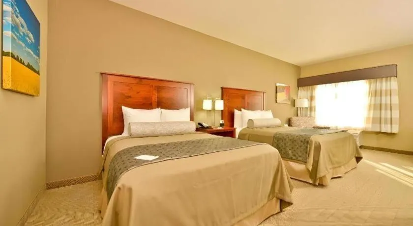 Bed in Green Mill Village Hotel & Suites, BW Signature Collection